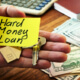 hard money loan written on note in someones hand and they are hodling a house key
