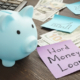 small piggy bank next to cash and a note that says hard money loans