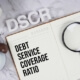 journal with debt service coverage ratio written inside and magnifying glass
