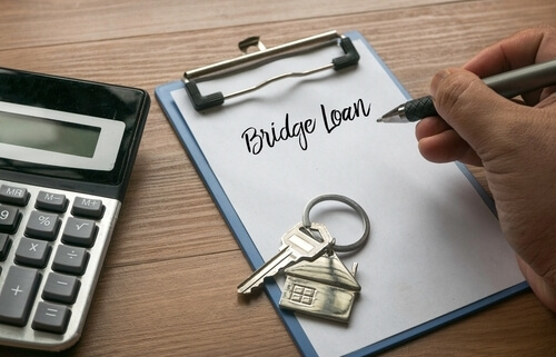 bridge loan written on clip board with house keys