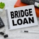 bridge loan written on notepad next to calculator