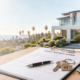 hard money loan documents on a table with a california house backdrop