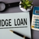 bridge loans on a piece of paper next to a calculator