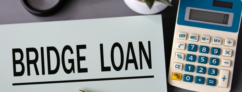 bridge loans on a piece of paper next to a calculator